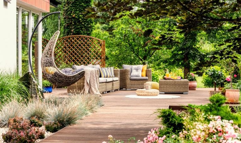 Hanging,Chair,And,Pouf,On,Wooden,Veranda,In,The,Middle