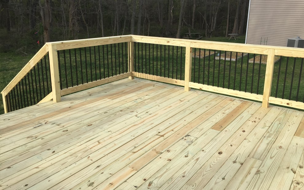 Pressure Treated Decks - Wood deck with black aluminum baluster railing-min