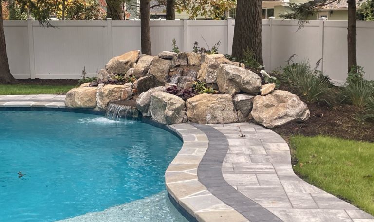 white vinyl Pool Code fence surrounding beautiful pool-min