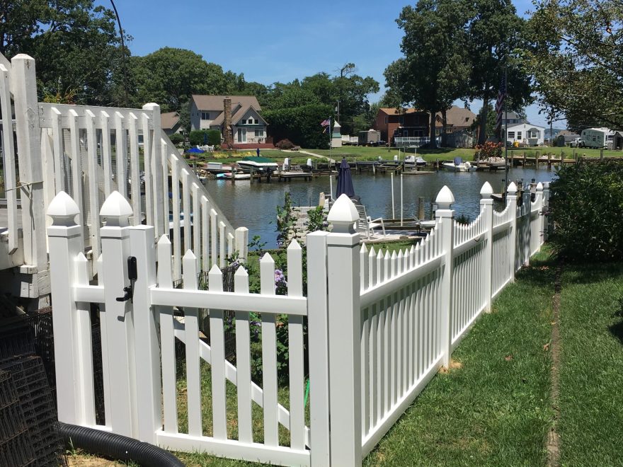 4 foot high white contemporary spaced pointed picket vinyl fence with scalloped layout and french gothic post caps