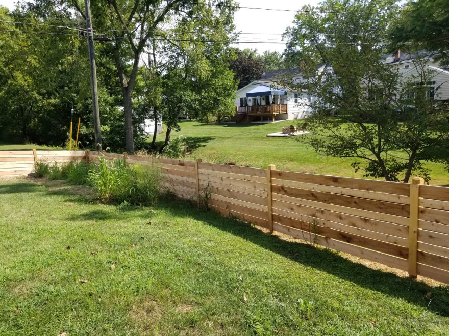 42 inch high cedar horizontal semi-privacy fence with alternating 1 x 4 and 1 x 6 spaced cedar boards and Dog Ear posts