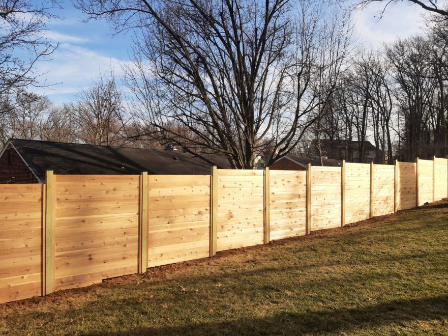 6 foot Horizontal cedar stepped fencing with no spacing between the pickets with standard black post caps (3)