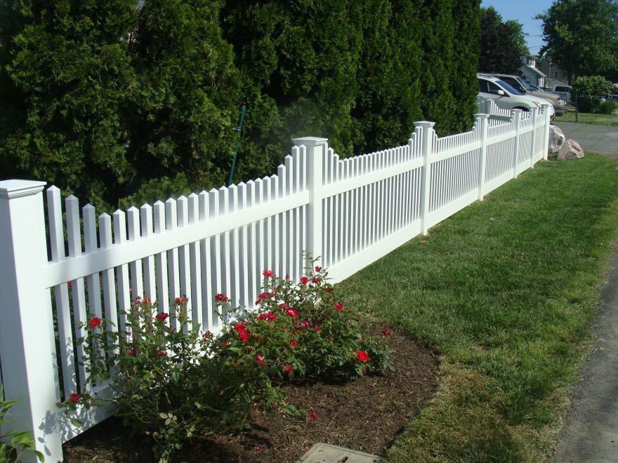 Classic white vinyl picket fence with architectural detail